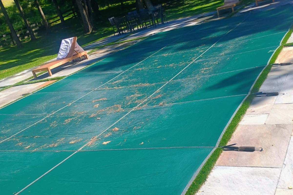 Pool cover installed at sunset with fall leaves